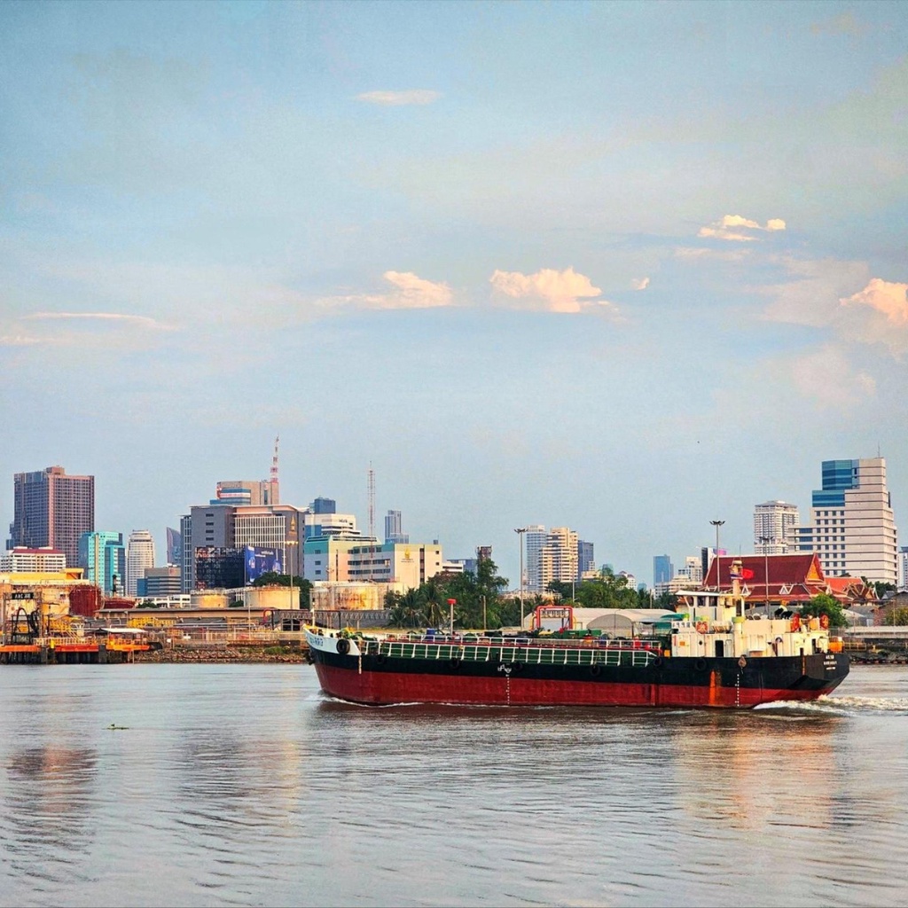 A large boat next to a city
