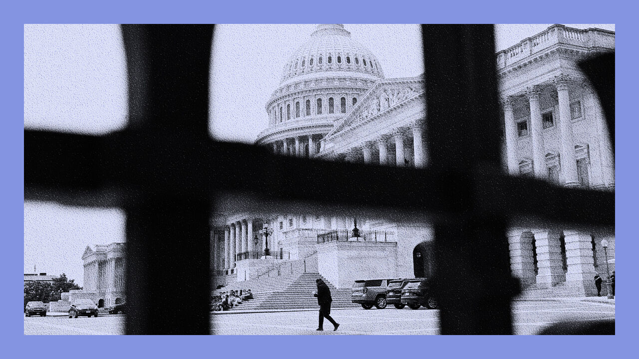 The US Capitol building is seen behind a black metal fence on Capitol Hill, in Washington, DC, USA.