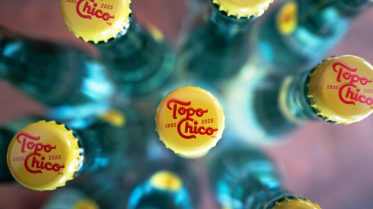 Bottles of Topo Chico carbonated mineral water are shown.