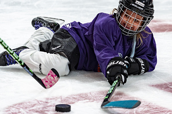 Kid cheerfully playing Ice hockey
