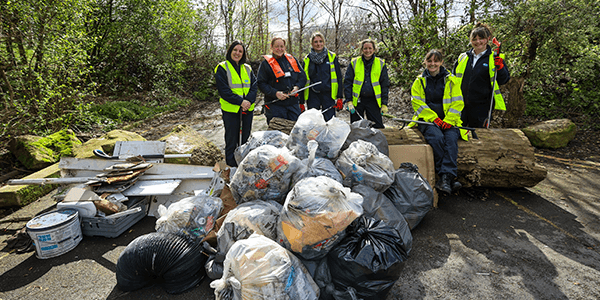 RSPCA staff and volunteers stand behind the pile of litter they collected as part of the Great British Spring Clean 2024