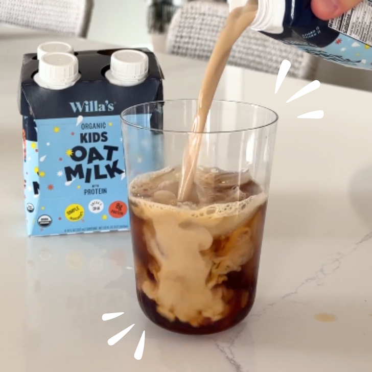 Willa's Kids Oat Milk with Protein pouring into an iced coffee