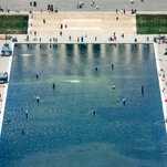 The Reflecting Pool is seen, with blue and green tints in the water.