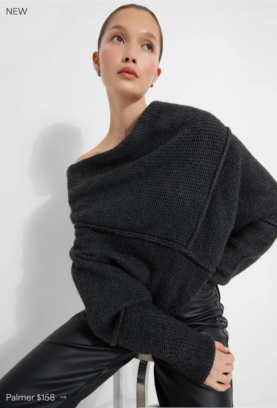Yada poses in The Palmer Long Sleeve Top with leather pants against a plain background.