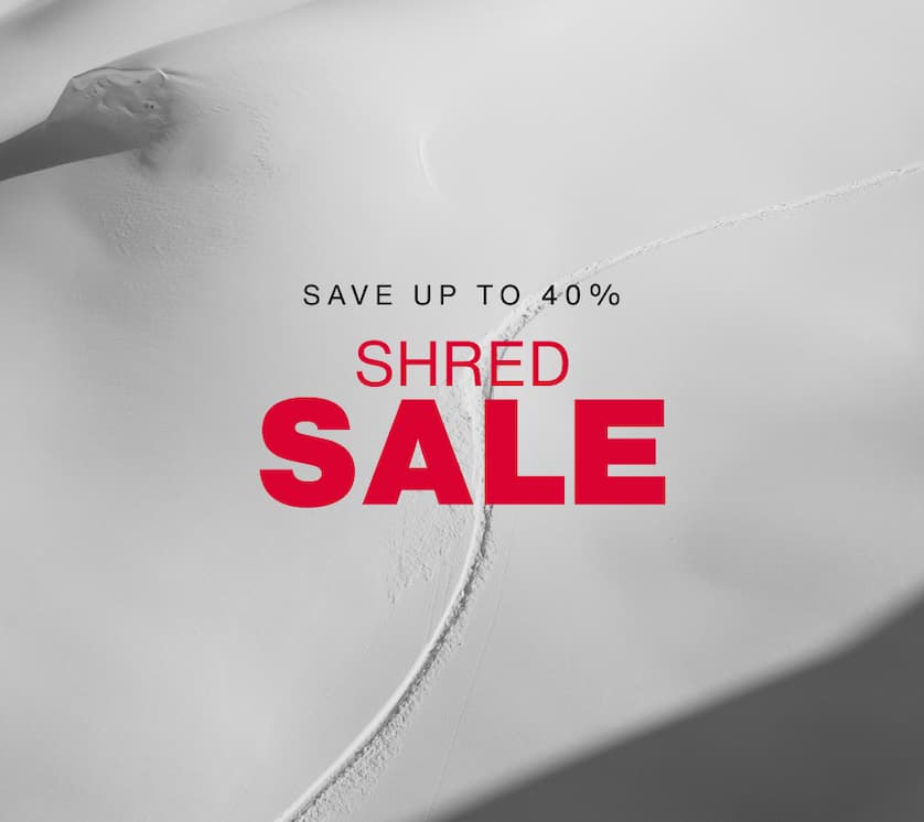 Darkened image of a rider's line in the backcountry. The text SHRED SALE repated in white on a red background a the bottom. Underneath, the text 'Sale runs 3/4-3/11. Save up to 40%'.'