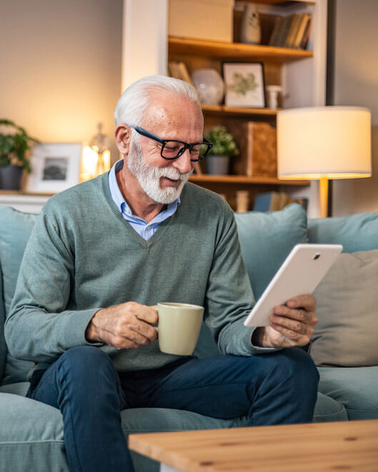 older man reading his iPad