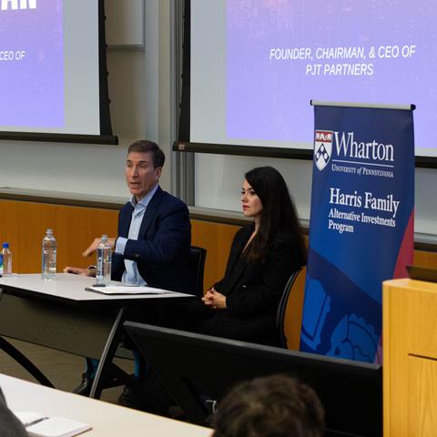 Two speakers engaged in a fireside chat