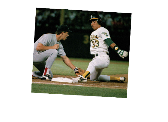 Conseco slides into a base while the baseman attempts to tag him out.