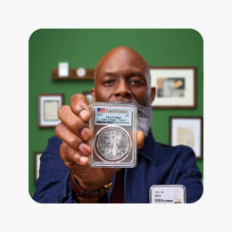 A seller holding a graded marquee coin.
