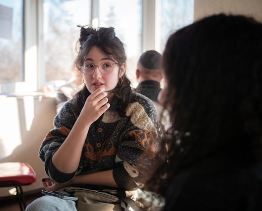 Two students speaking to each other.