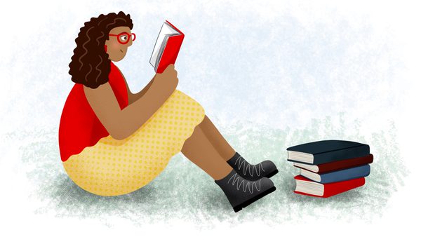 woman sits on ground and reads book, with stack of books beside her