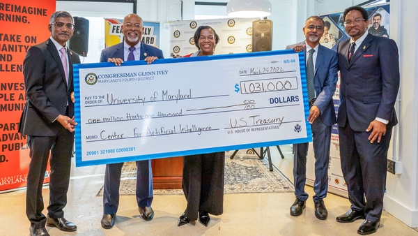 five people hold giant check for $1,031,000 made out to the University of Maryland