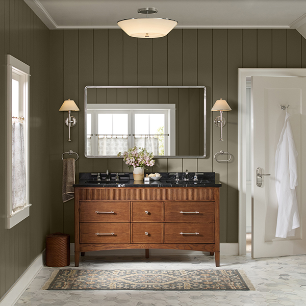A green paneled bathroom with marble-and-wood his-and-hers sinks.