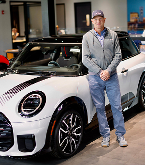 Man posing in front of white MINI