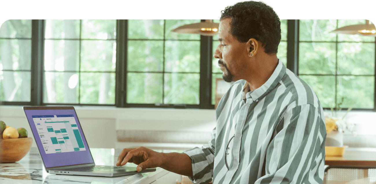 A man checking his calendar on his laptop