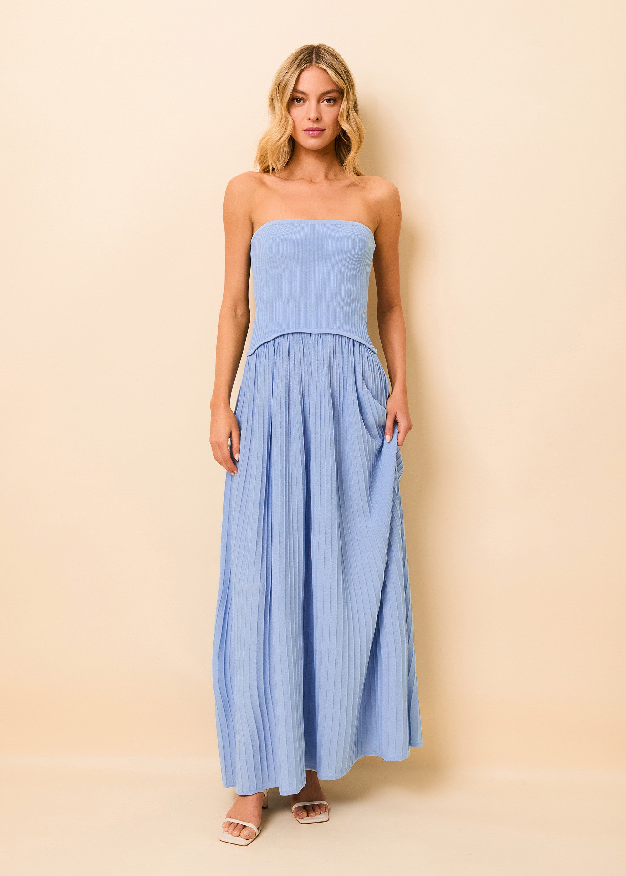 woman in strapless blue dress with a tight bodice and flowing skirt