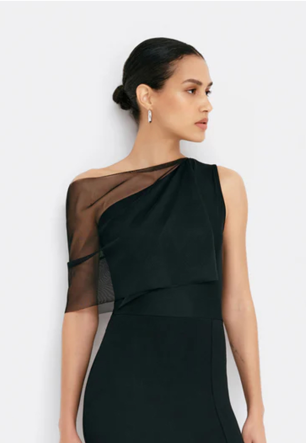 Astrid wears The Zinnia Dress with a sheer mesh sleeve.