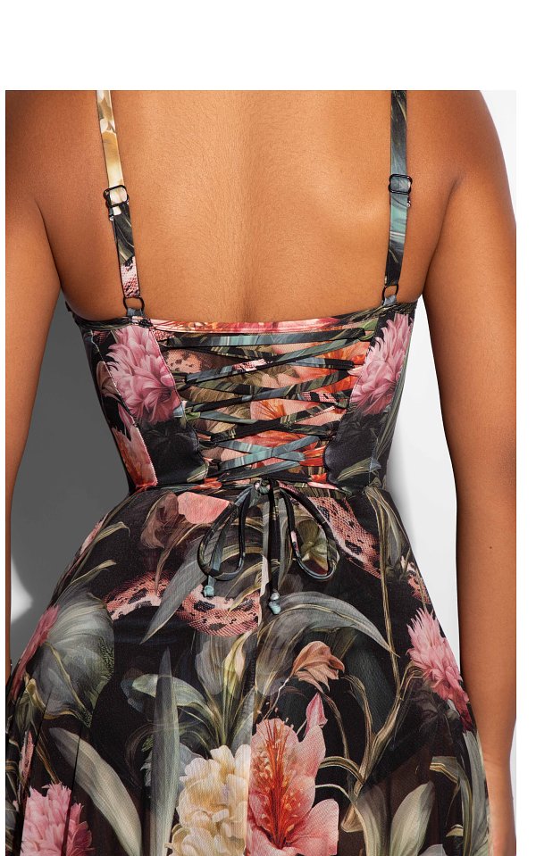 Back view of a dress with floral patterns and lace-up details.