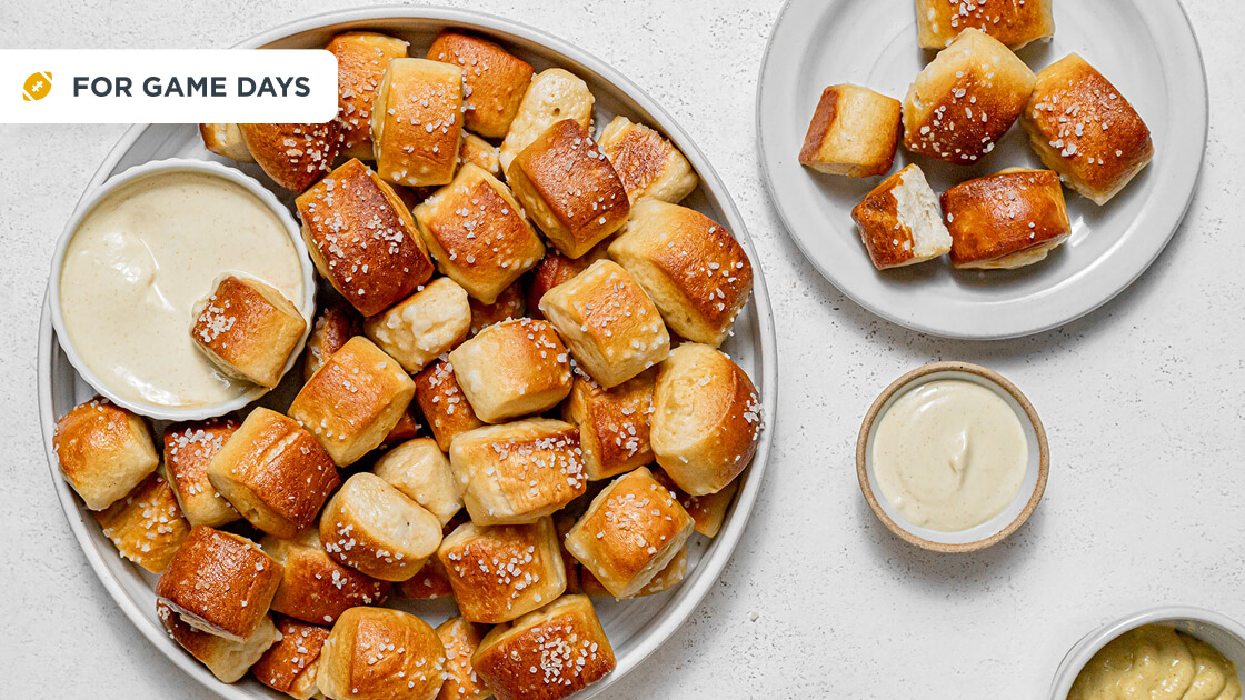 Pretzel bites in a large bowl with a dip bowl.