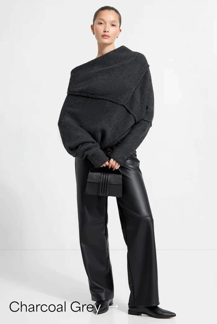 Yada stands in The Palmer Long Sleeve Top, black leather pants, and a small structured clutch, labeled “Charcoal Grey”