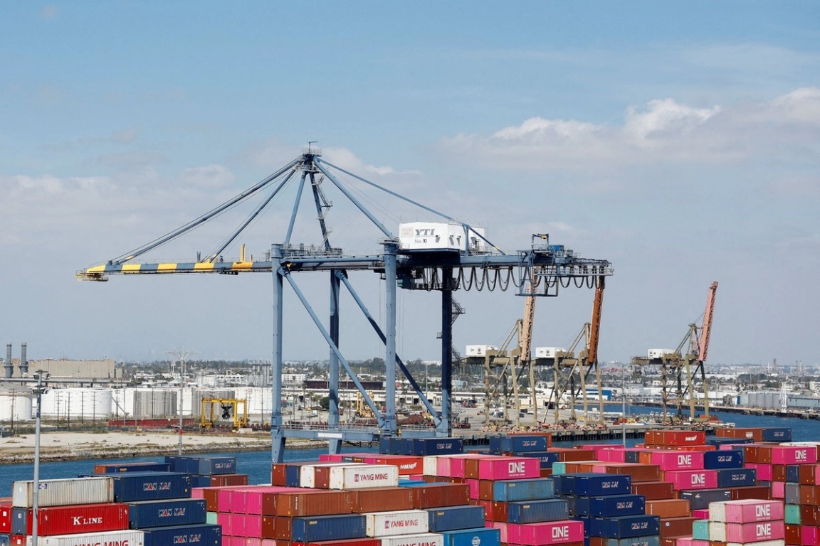 Shipping containers are stacked at a terminal at the port of Los Angeles. 