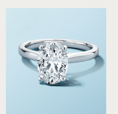 White gold solitaire ring with oval-cut diamond.