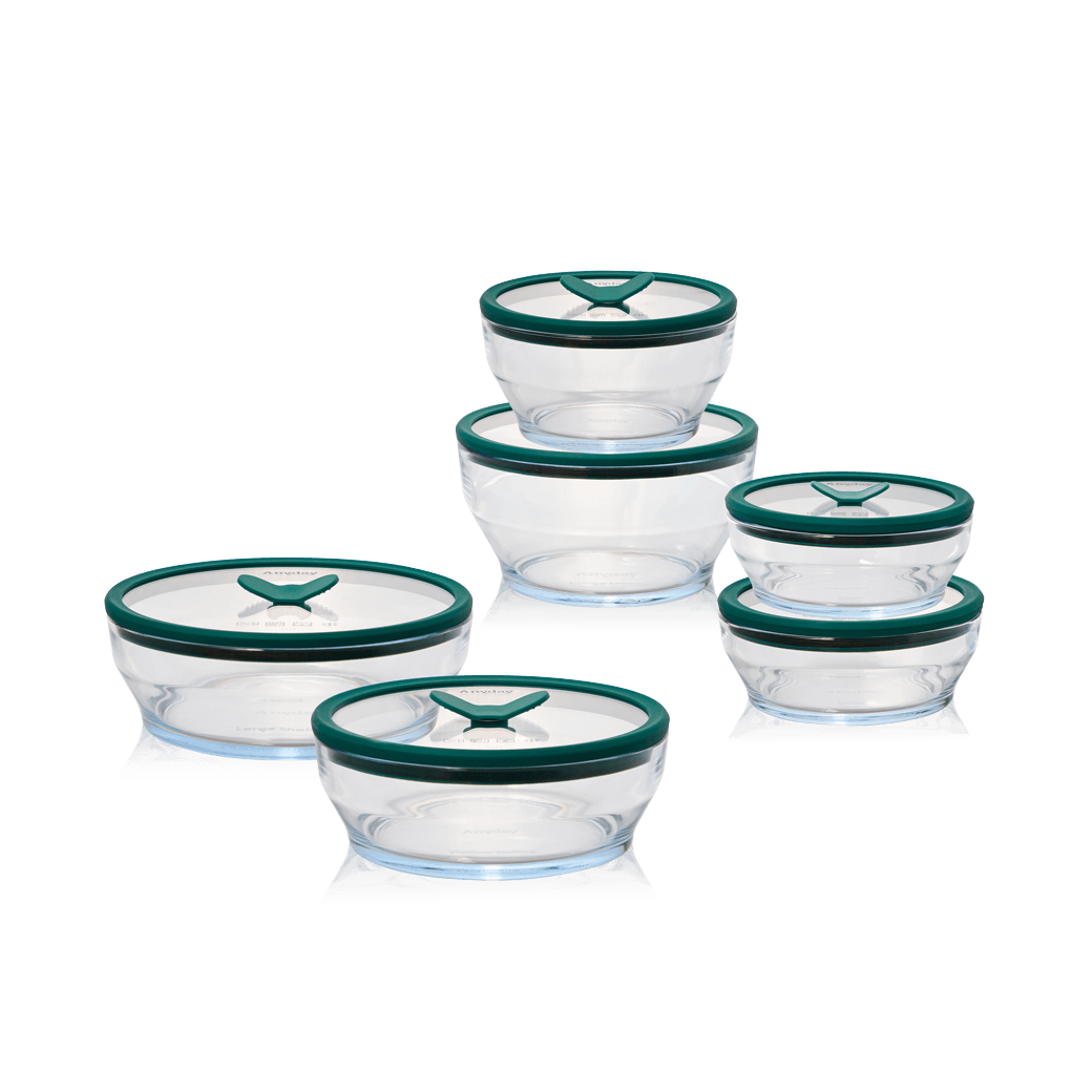 The Anyday Everything Dish Essentials Set, a plastic-free glass cooking and storage set with kale-green lids, shown with a "Under $100" label. This set includes essential dish sizes for everyday microwave cooking, storing, and reheating