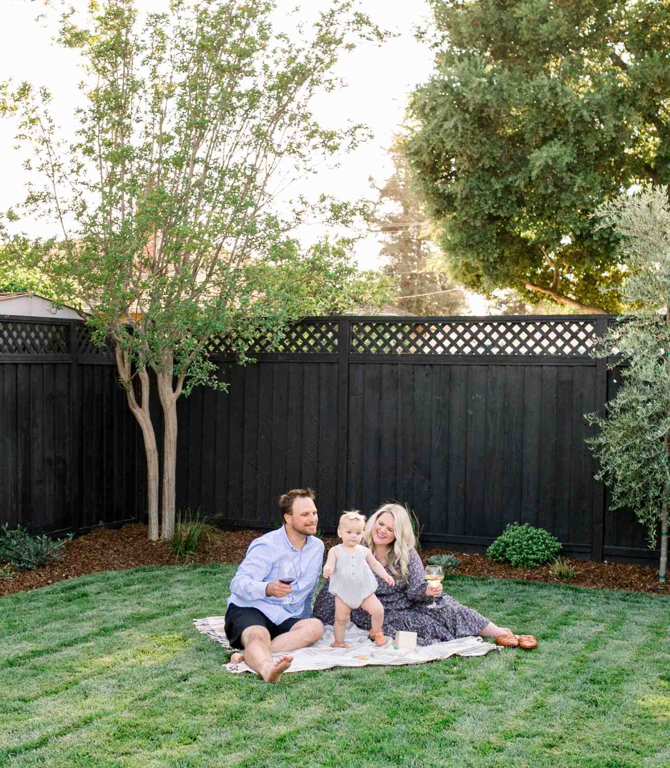 A photo of a couple standing in front of their refreshed exterior
