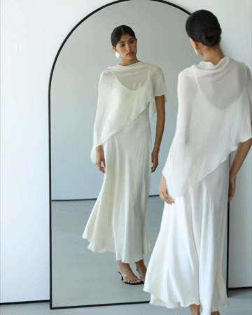 Model with the ivory satin dress draping fluidly