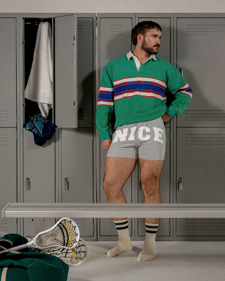 Man in locker wearing green long sleeve collard shirt and grey slim fit boxers with "NICE" on front