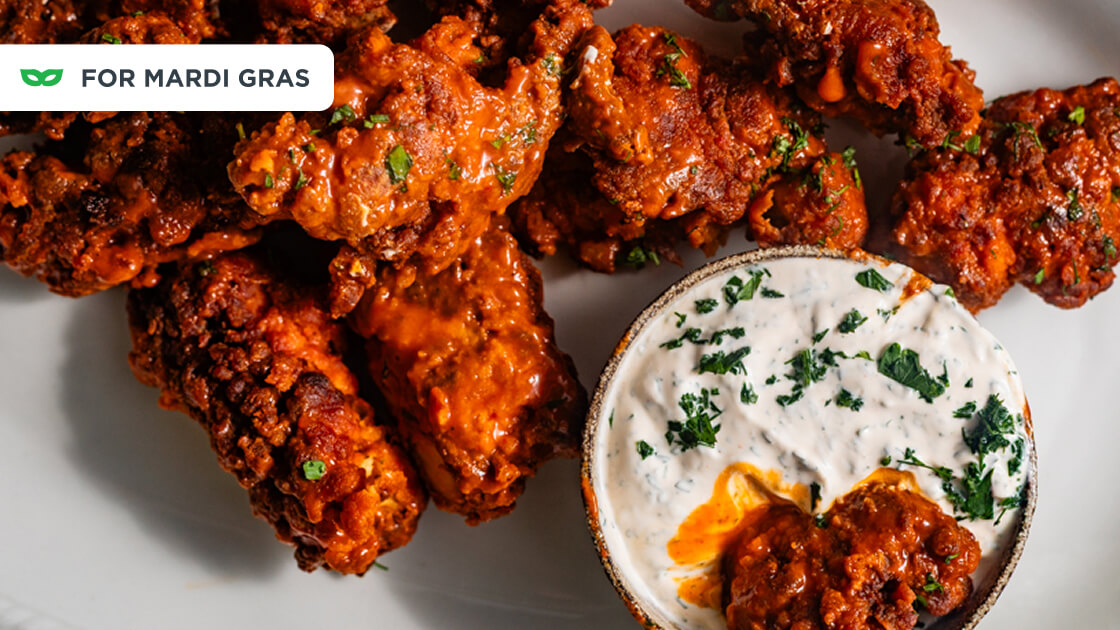   Close-up of buffalo chicken bites with a small dip bowl. 