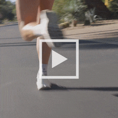 Rosie Edwards running outdoors, followed by a close-up of her hand picking up an Orange Salt Stick Pack from its box.