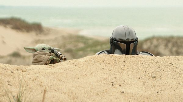 Pedro Pascal and Grogu in a scene from Lucasfilm's Star Wars: The Mandalorian and Grogu.