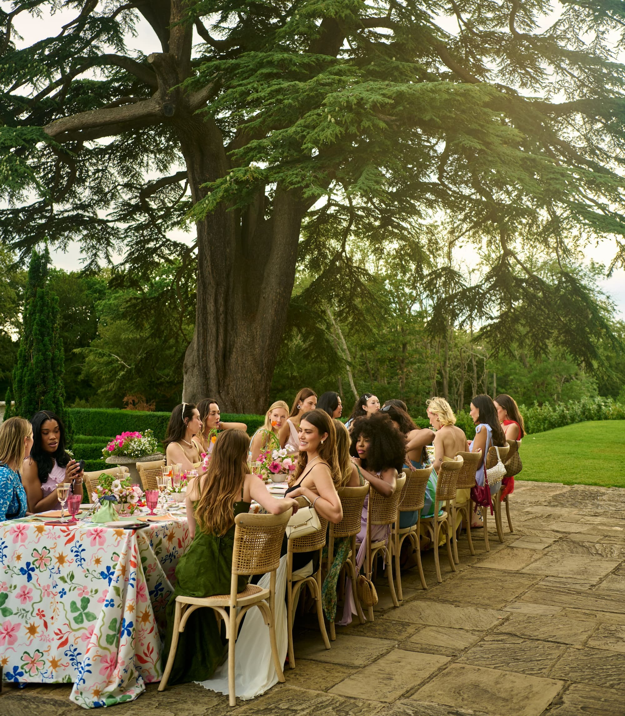 Intimate alfresco dinner at Hedsor House with guests wearing elegant Azazie occasion dresses