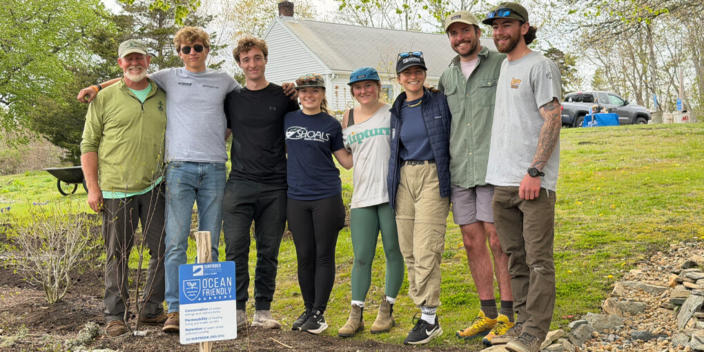 Eight volunteers huddle for a photograph at a new ocean friendly garden in Orleans, MA.