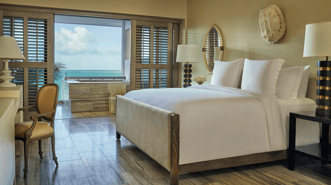 An elegant bedroom with an ocean view.