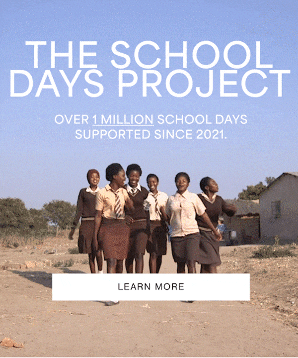 A group of schoolgirls in uniforms walk together outdoors, smiling and chatting. Text reads: The School Days Project - Over 1 Million School Days Supported Since 2021. Learn More.