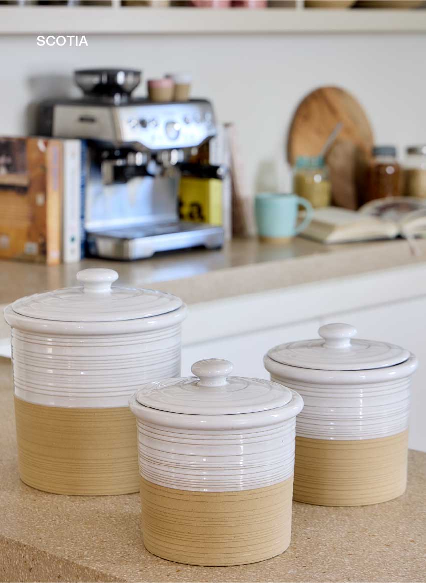 Block of four photographs of Ecogres collections: Marrakesh, with a brown lidded oven dish and a plate with gazpacho; Arenito, with a pink and beige bowl with fruit and granola; Stacked Organic, with dark brown plates by a sink; and Scotia, with white and beige lidded jars on a kitchen counter