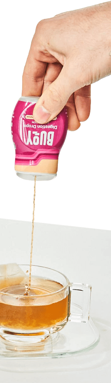 Digestion Drops being squeezed into tea.
