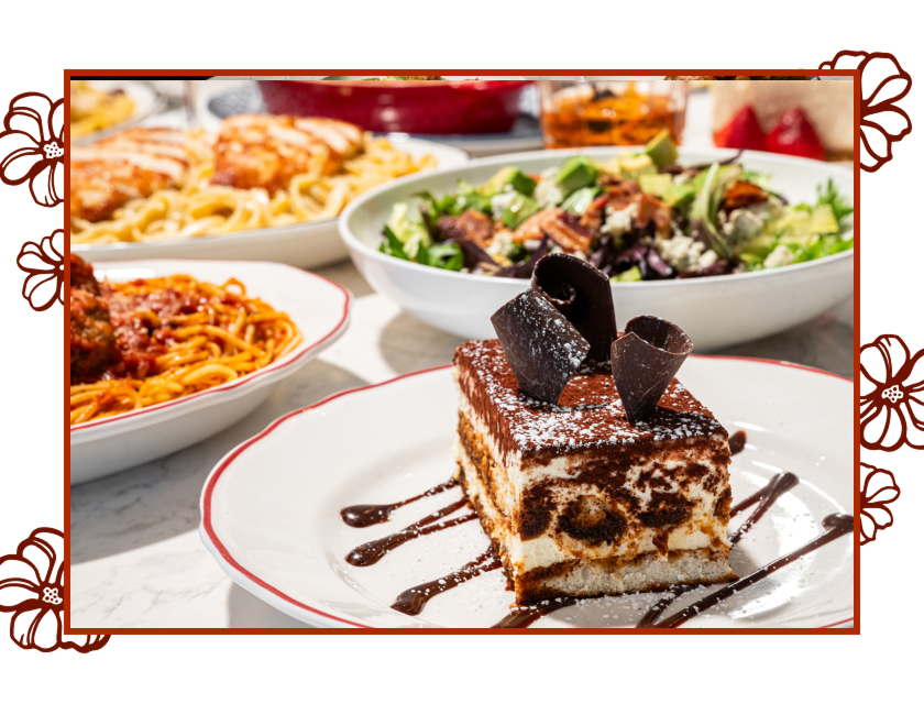 Close-up view of Maggiano’s Tiramisu. Several other Maggiano’s entrées appear in the background