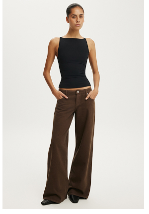 Woman wearing black sleeveless tank top and brown wide-leg pants