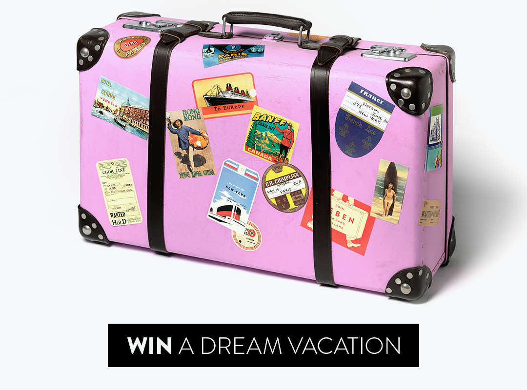 Photo of a pink hard-sided suitcase covered in travel stickers. Button: Win A Dream Vacation