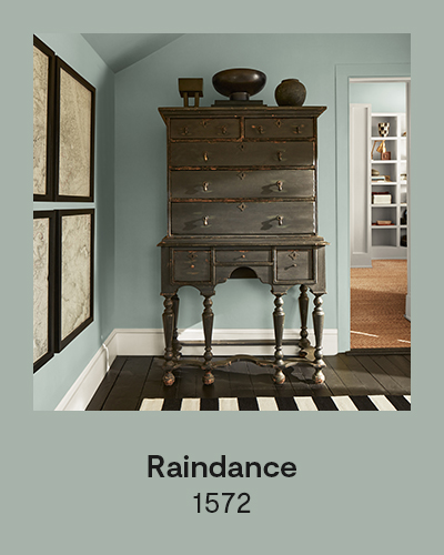 Raindance 1572 - A vintage armoire sits in front of light blue painted wall.