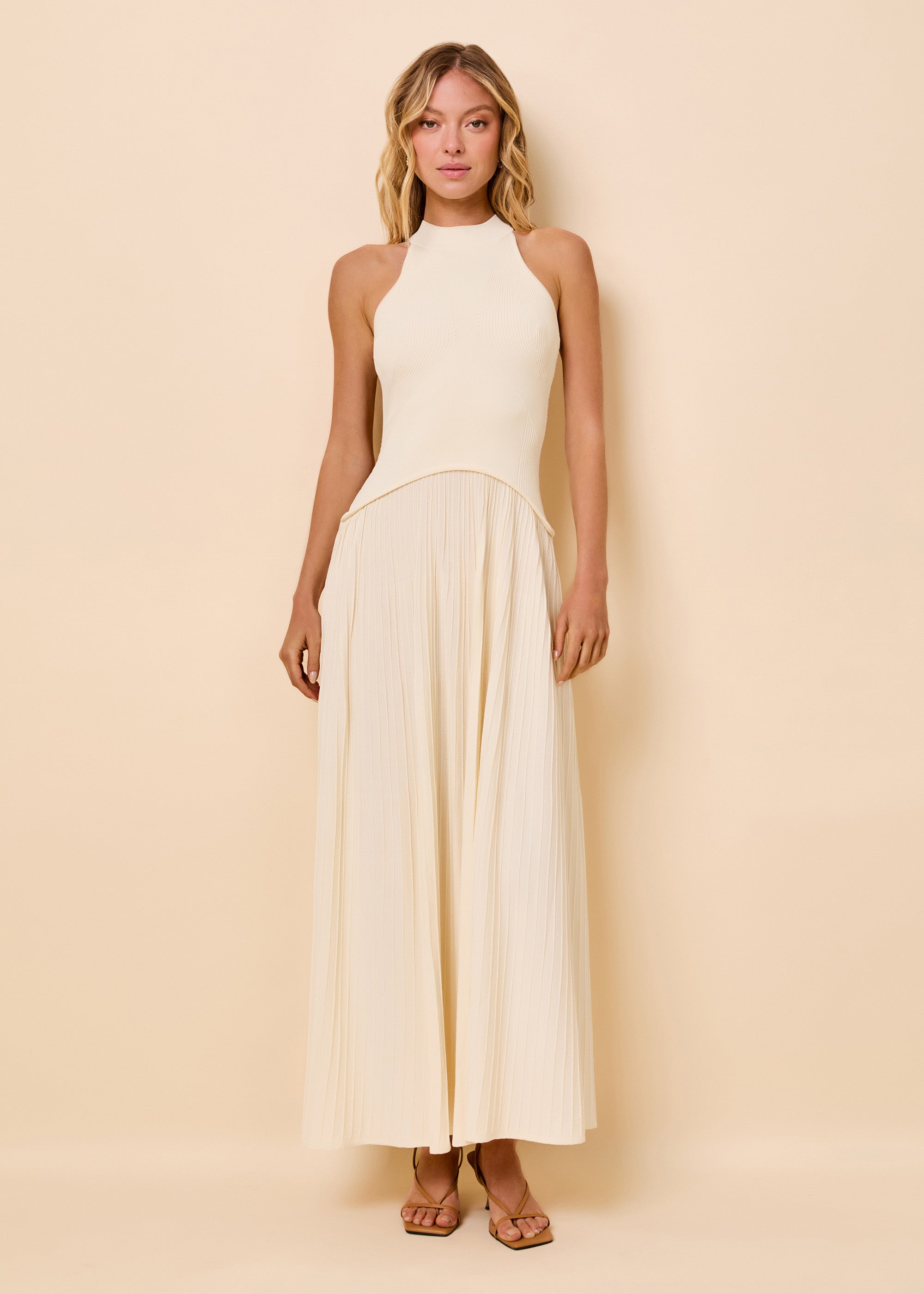 woman in ribbed bodice detailed dress in a cream color