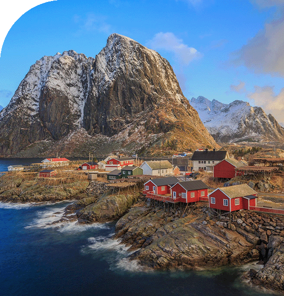 A quaint village nestled along the foot of majestic mountains.