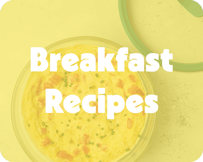 A yellow-toned image of a fluffy omelet in a plastic-free Anyday dish with a kale-green lid, overlaid with bold white text that reads "Breakfast Recipes."