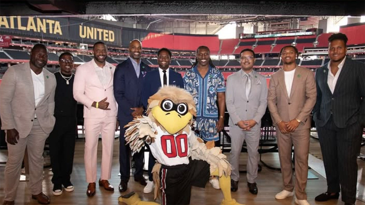 Freddie Falcon posing with members of Big Brothers Big Sisters ATL