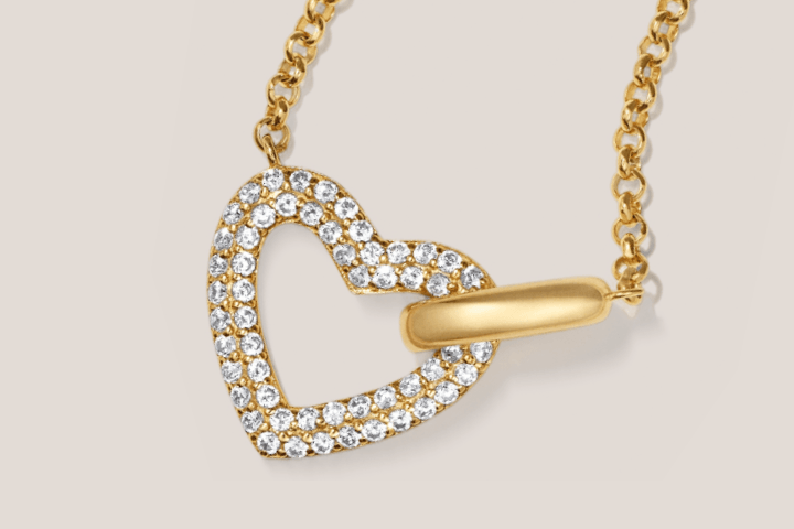 Yellow gold open heart-link pendant with pavé diamond details on dainty chain.