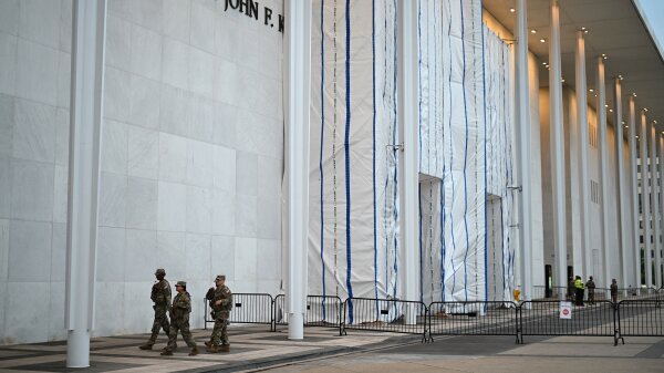 The Kennedy Center with its facade signage still covered by a tarp and scaffolding.