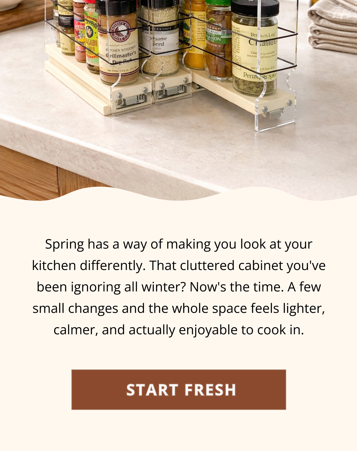 Close-up of a tiered spice organizer neatly arranged in a kitchen cabinet, making spices easy to see and access without digging around